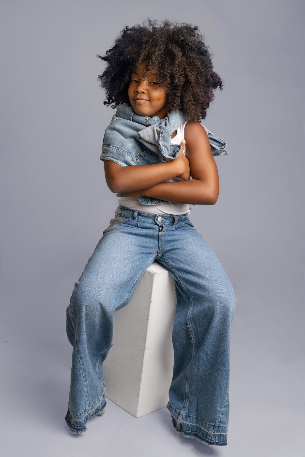 Girl in a denim vest and wide leg jeans