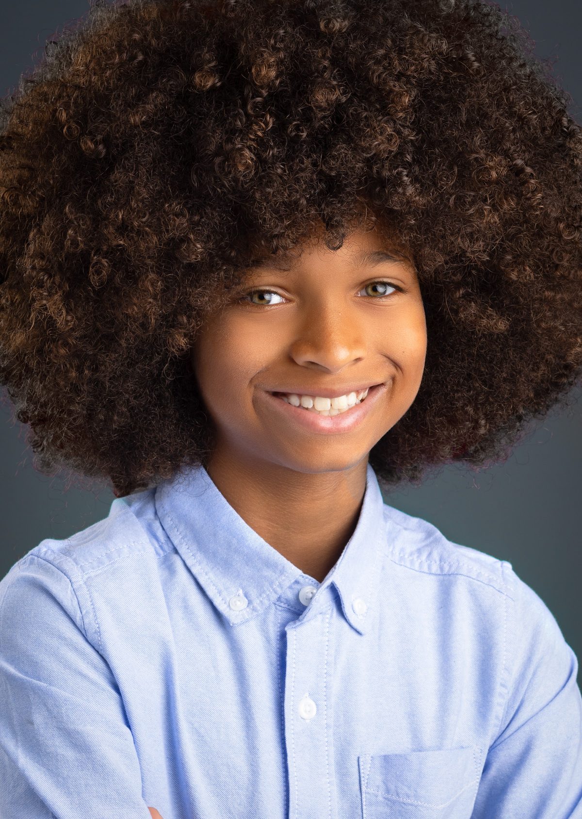 Boy headshot in a light blue button-down