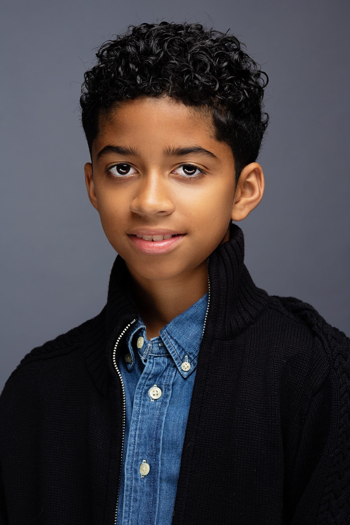 Boy in a navy jacket over a denim shirt